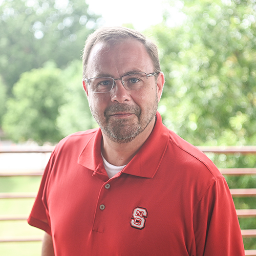 Patrick Neal wearing a red NC State polo